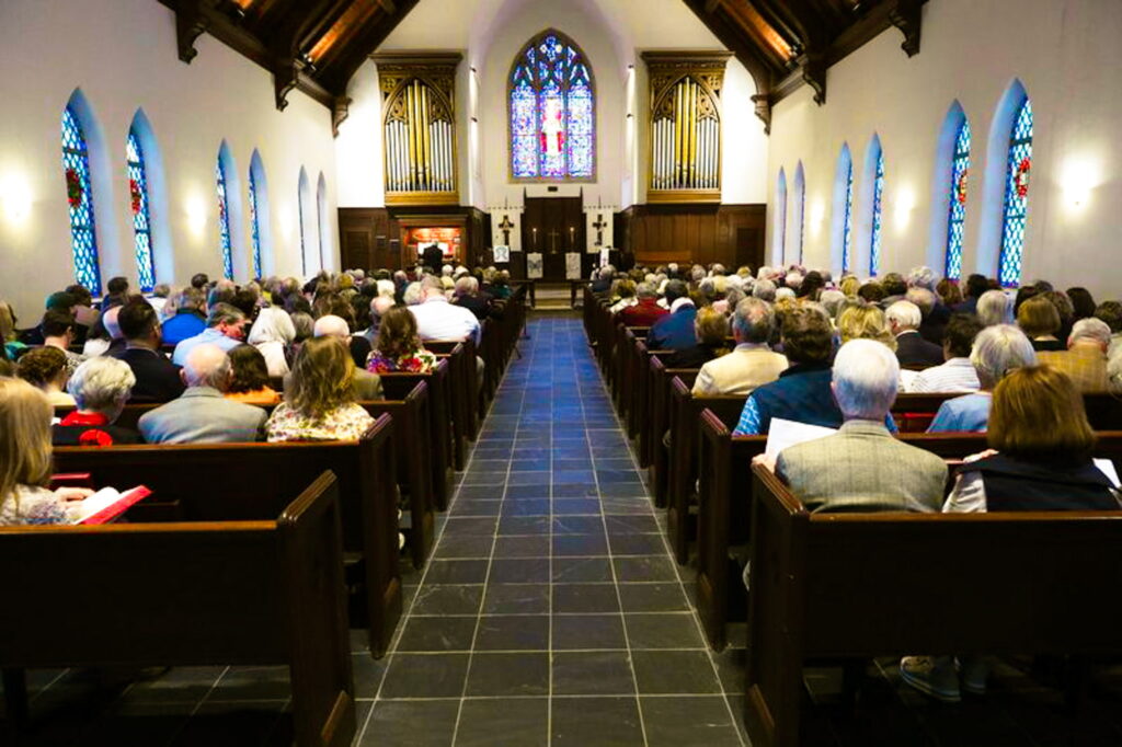 Interior of Greene Chapel filled with people sitting in pews.