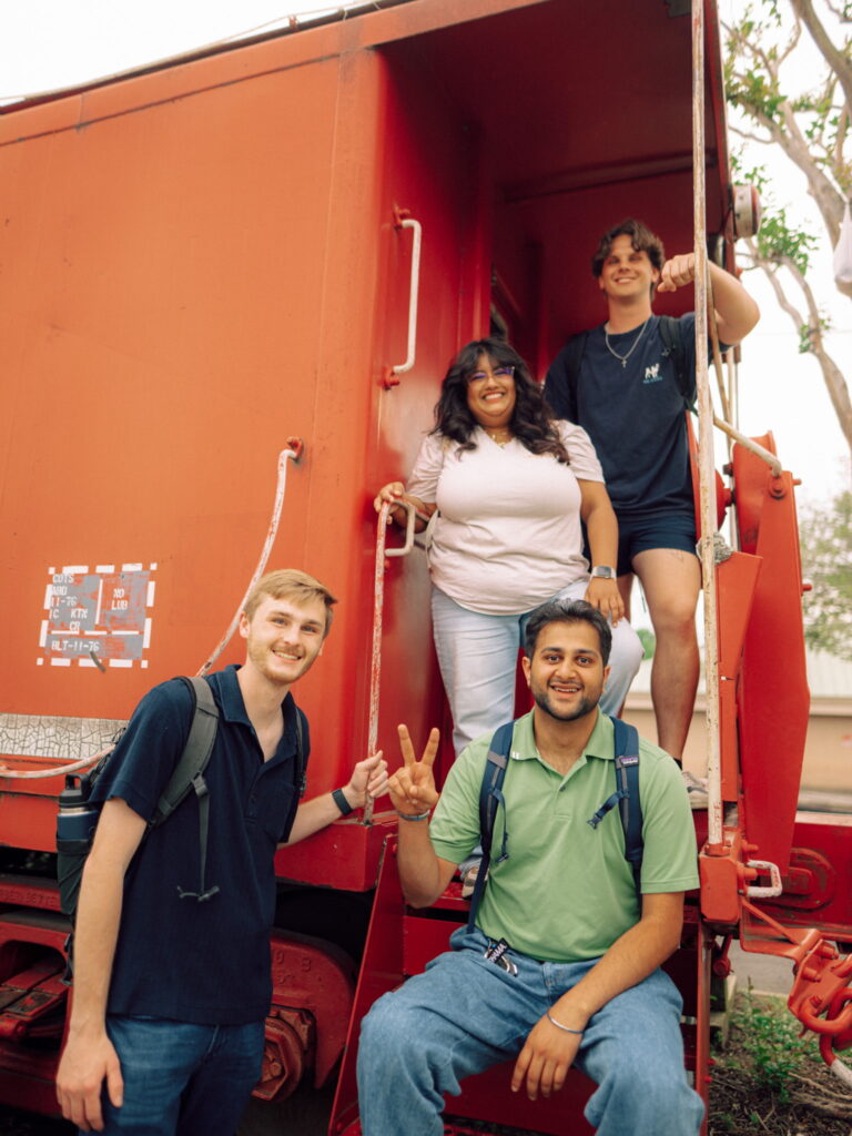 A group of Hendrix students on the back of a train car in Conway, Arkansas.