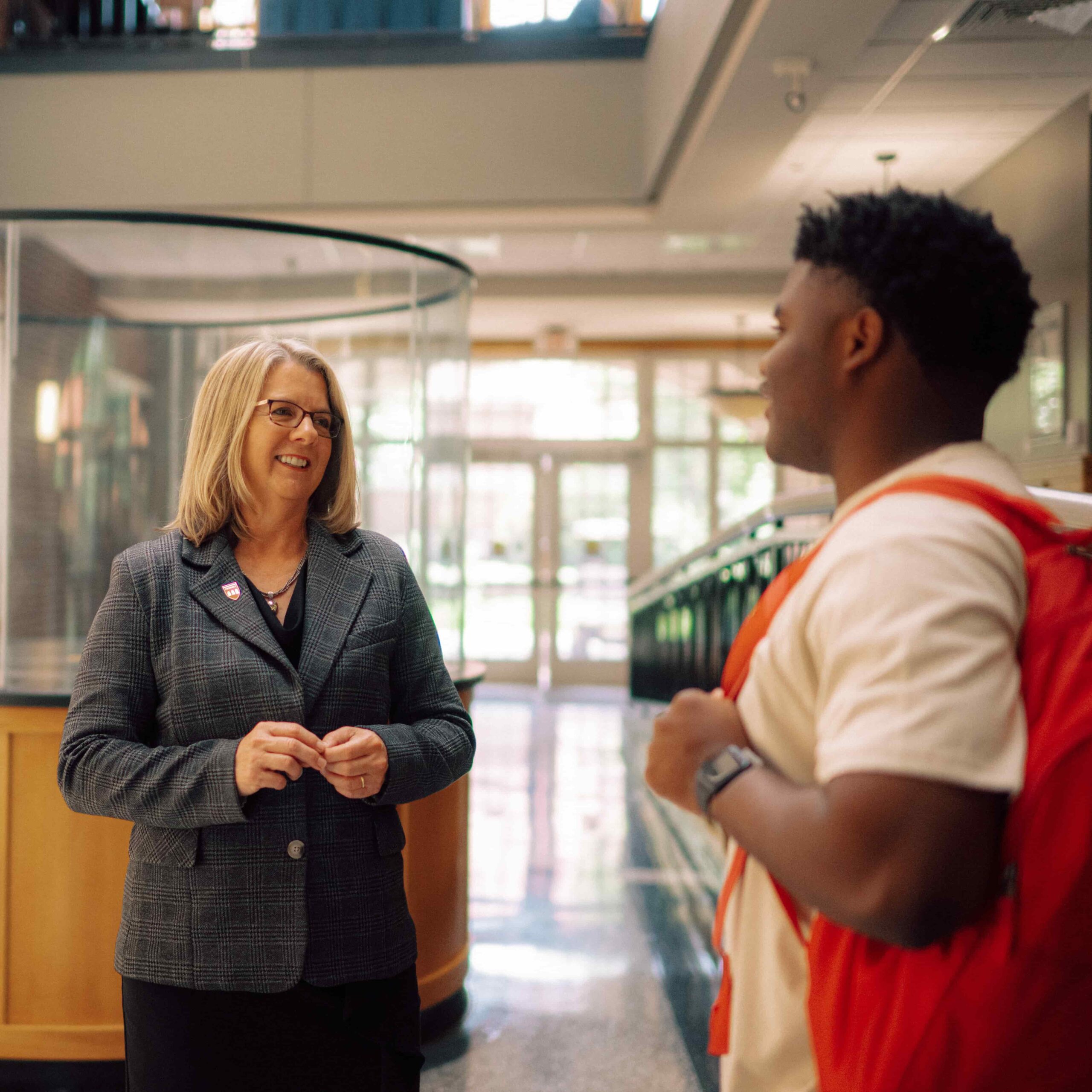 President Petersen speaks with a student.