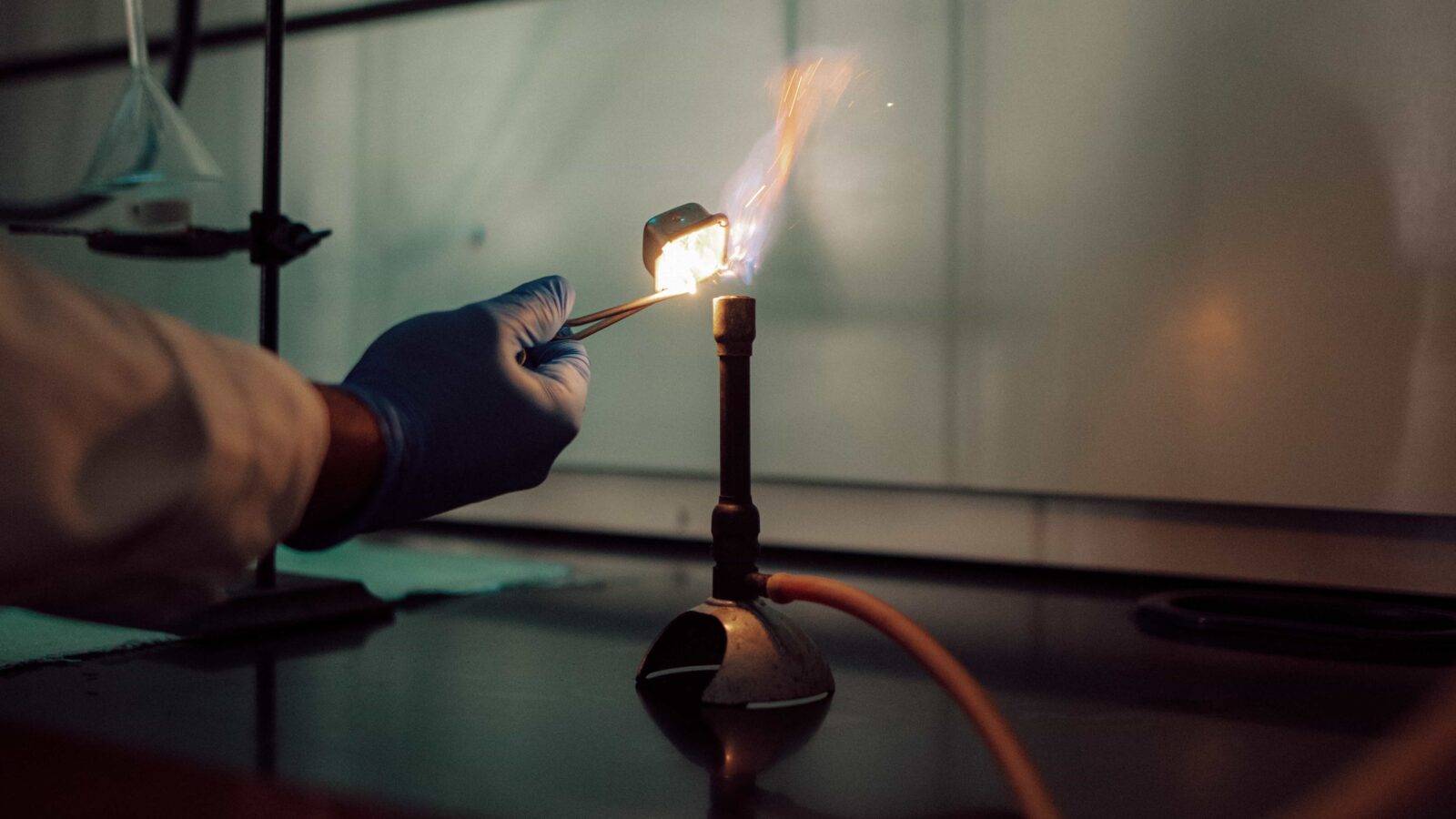 A Bunsen burner being lit in a science lab.