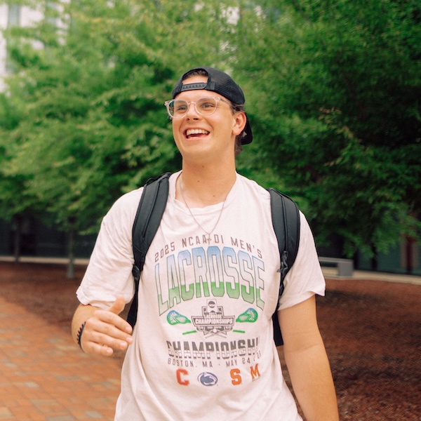 Kellan Harger, wearing a backpack while walking on campus.