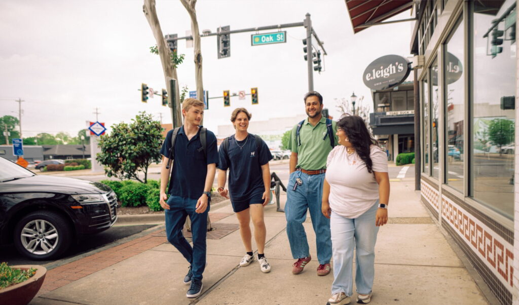 Hendrix students walking on the sidewalk in Conway, Arkansas.