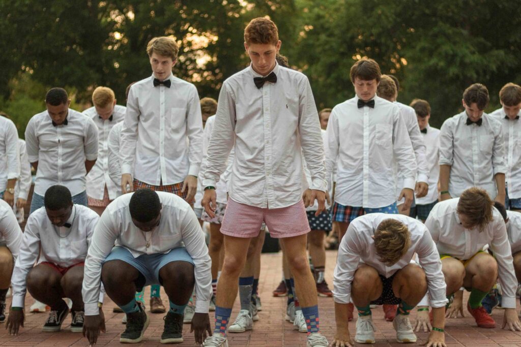 A group of male students preparing to perform during Shirttails.