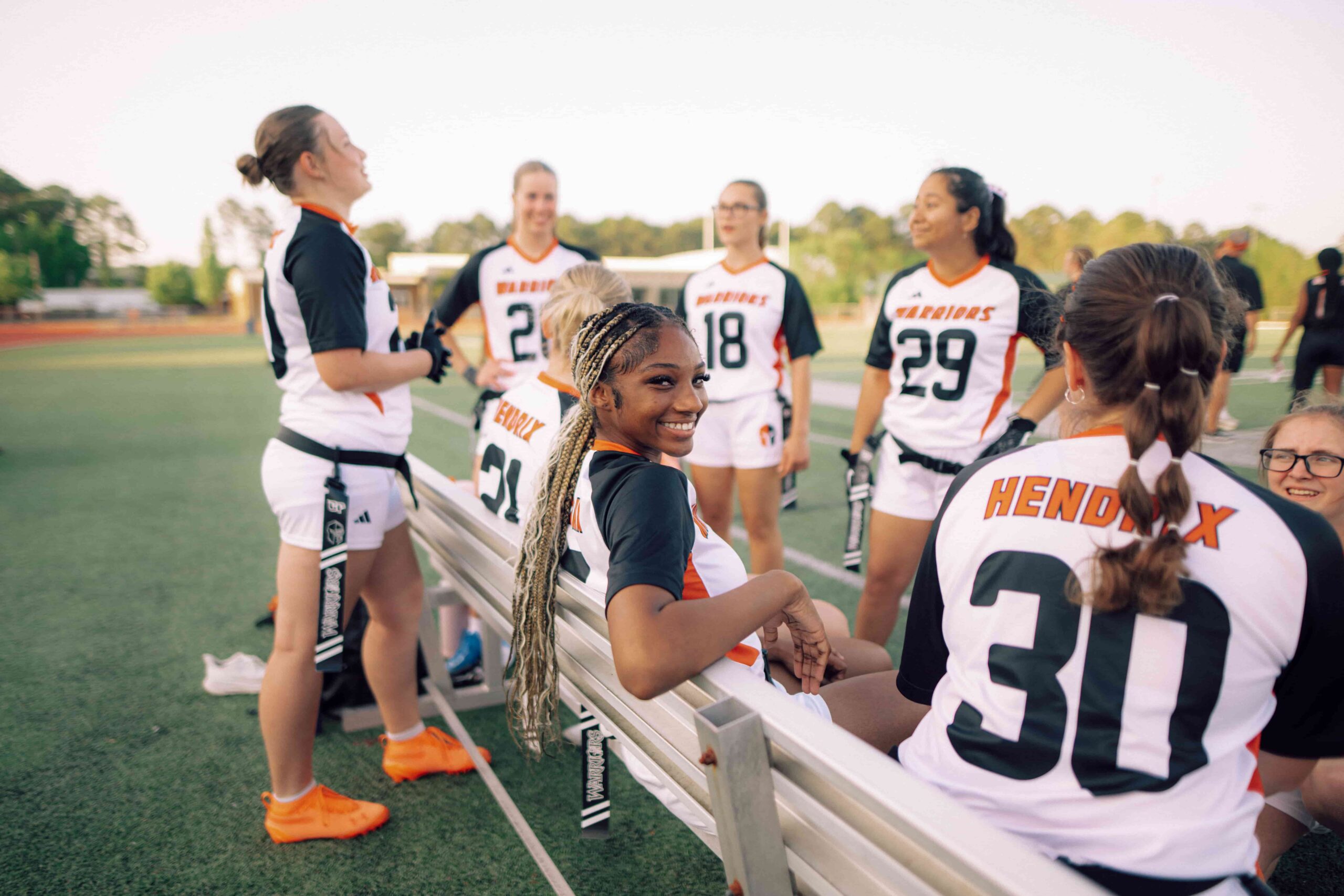 A group of female Hendrix student athletes wearing flag football uniforms.