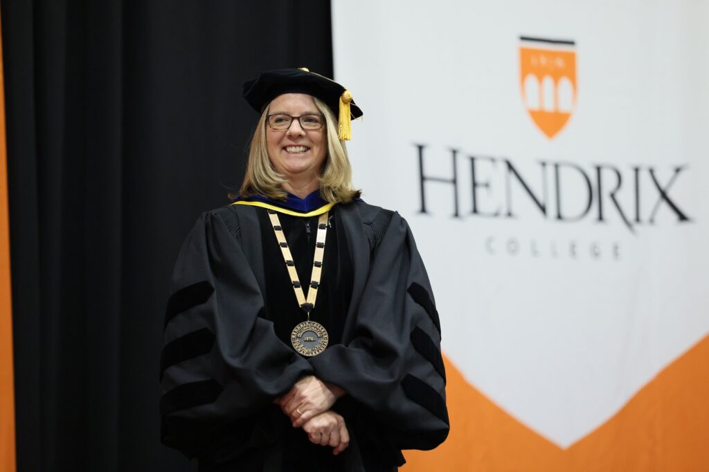 President Petersen stands in Commencement regalia.