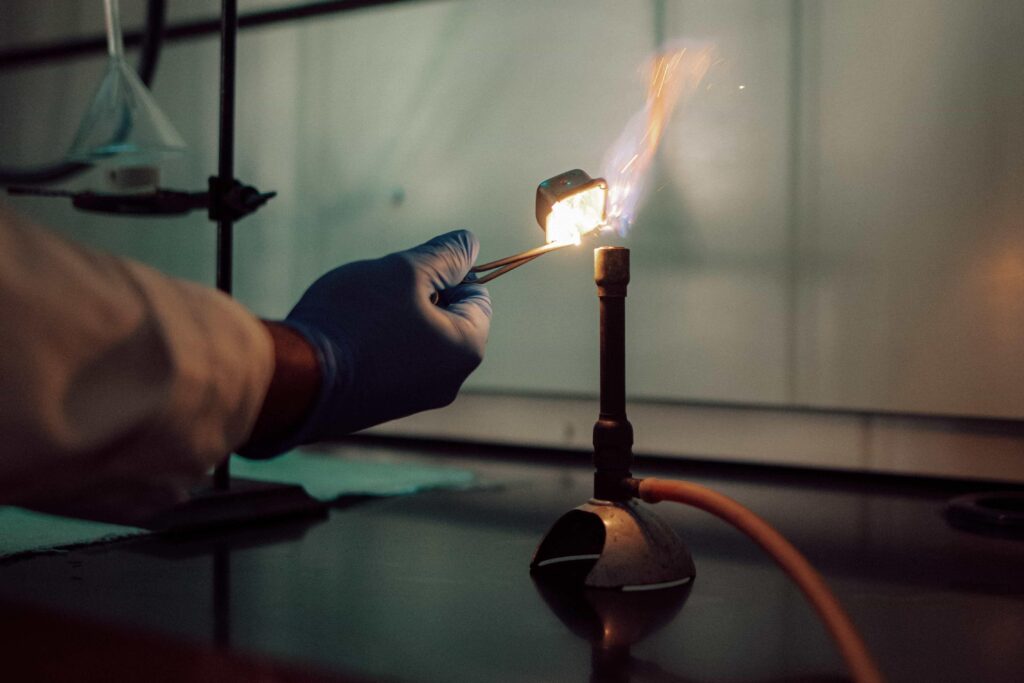 A Bunsen burner being lit in a science lab.