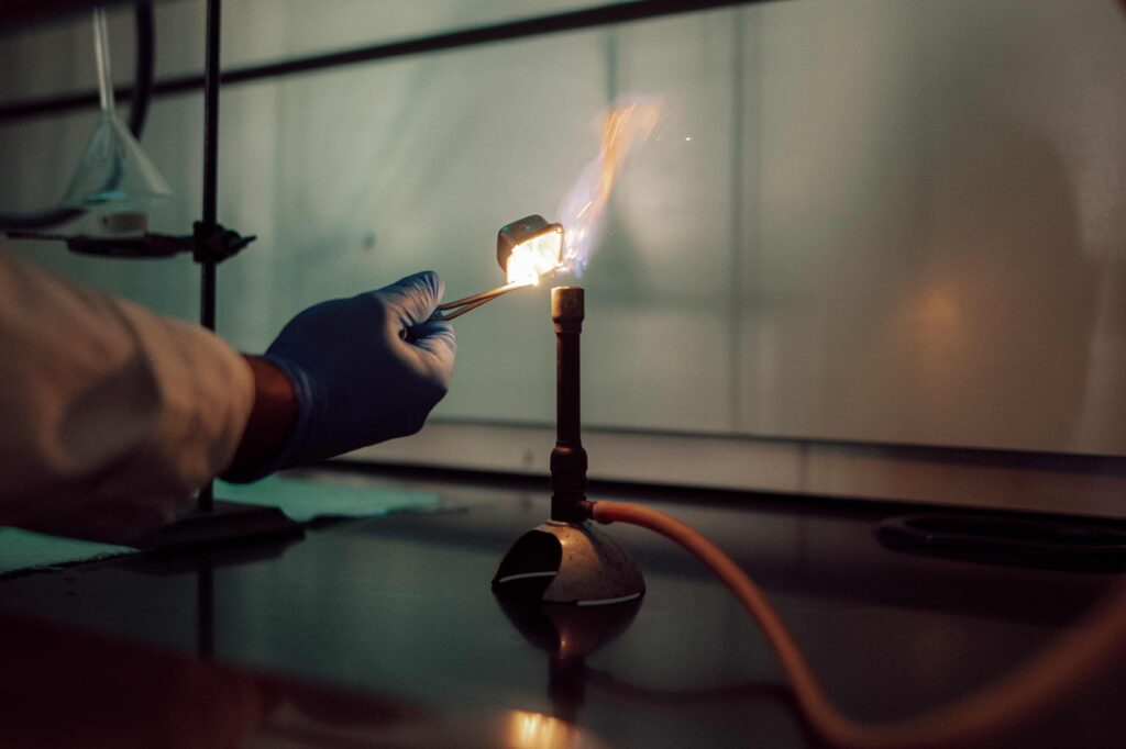 A Bunsen burner being lit in a science lab.