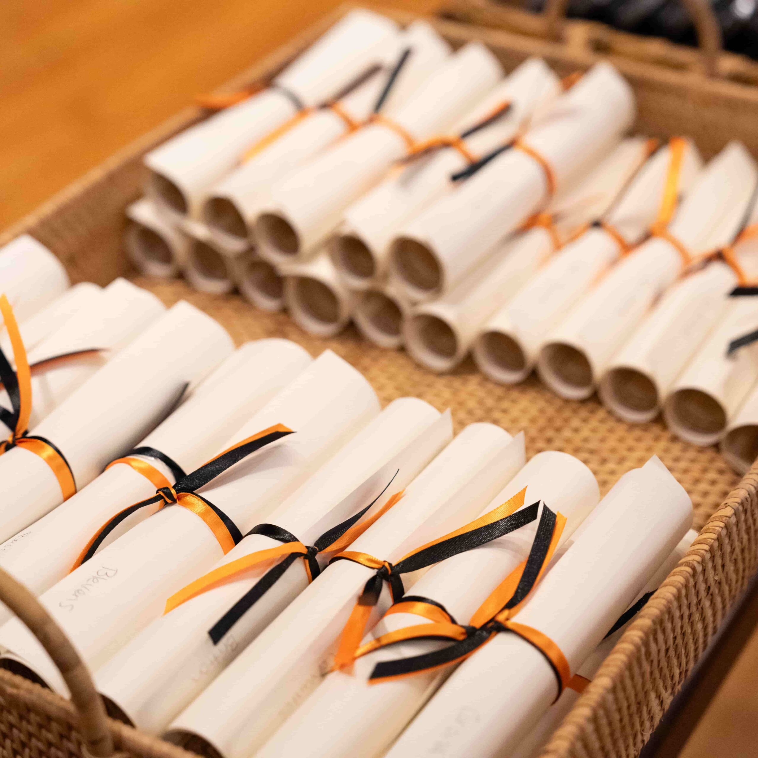 Stacks of paper scrolls in a wooden tray.