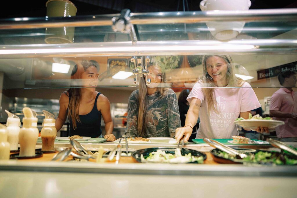 Three students visit the salad bar in the Hendrix Caf