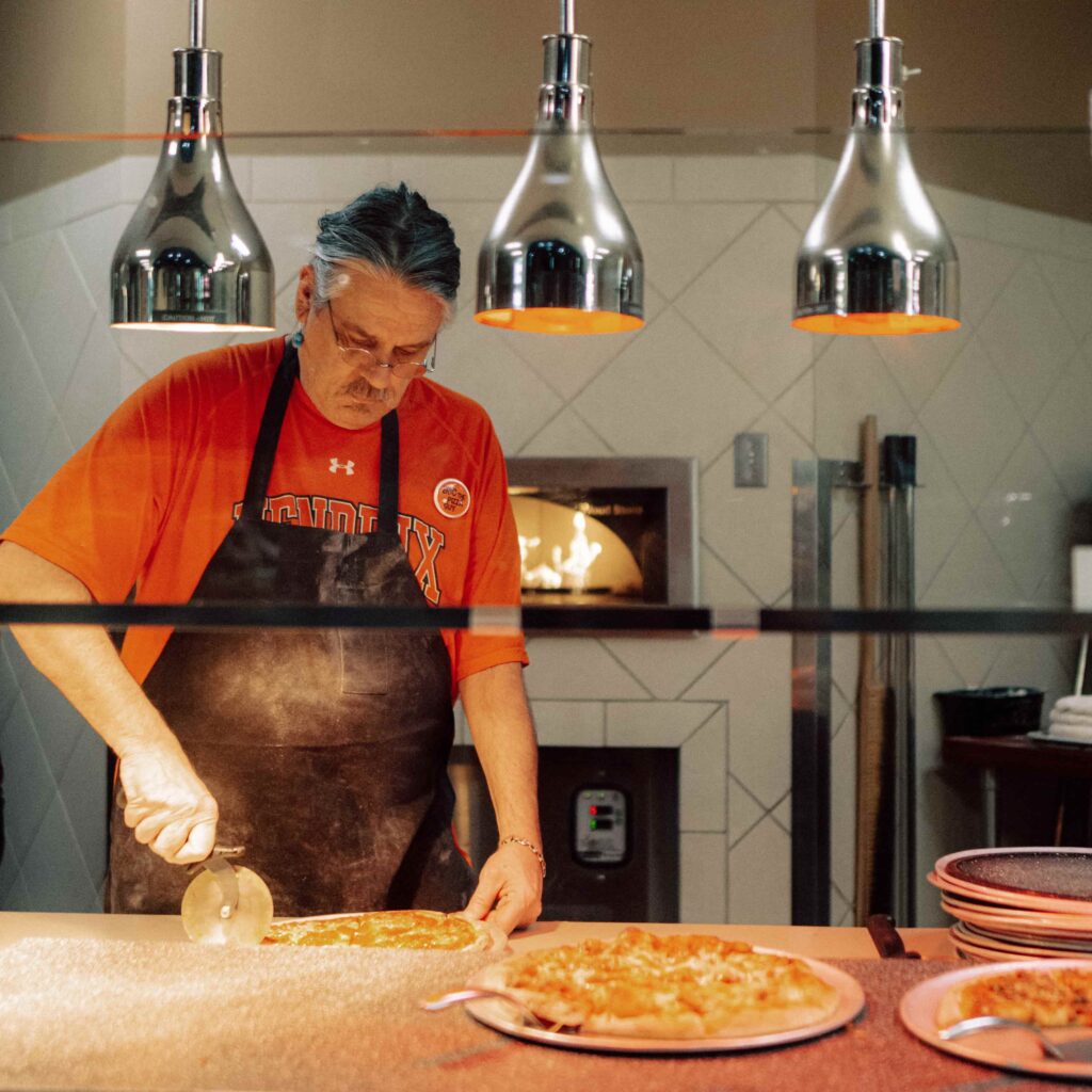 Eric the Pizza Guy makes pizza at the World’s Fare section of the Hendrix Caf