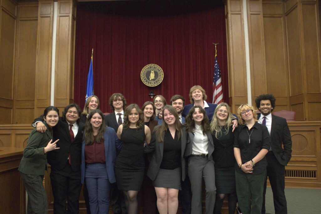 The Hendrix Mock Trial Association stands together in a courtroom.