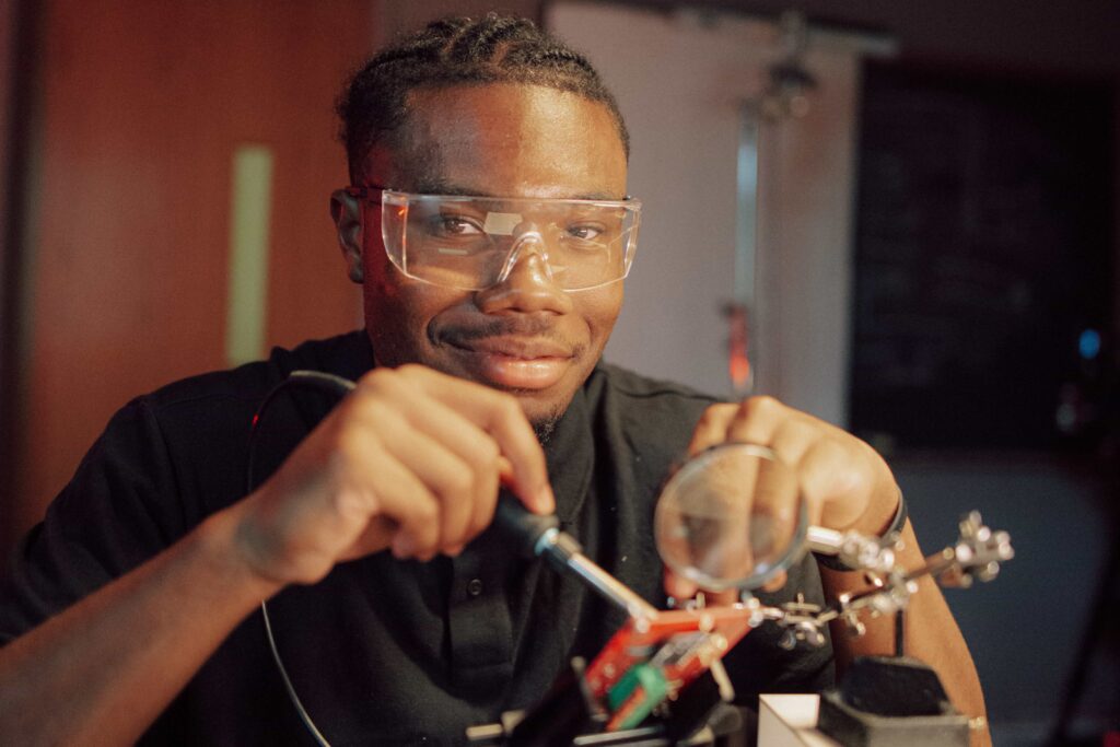A student wearing goggles while working in a lab.