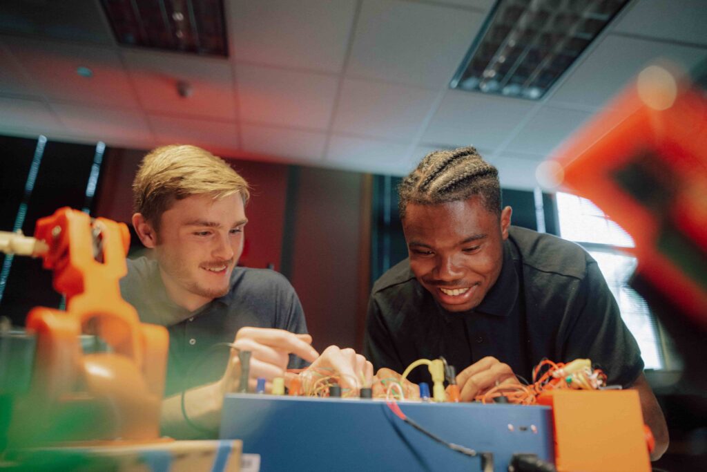 Two students work on a project together in a science lab.