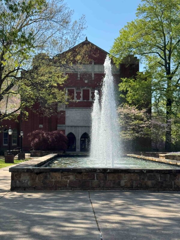 A view of Staples Auditorium with a fountain in the foreground.