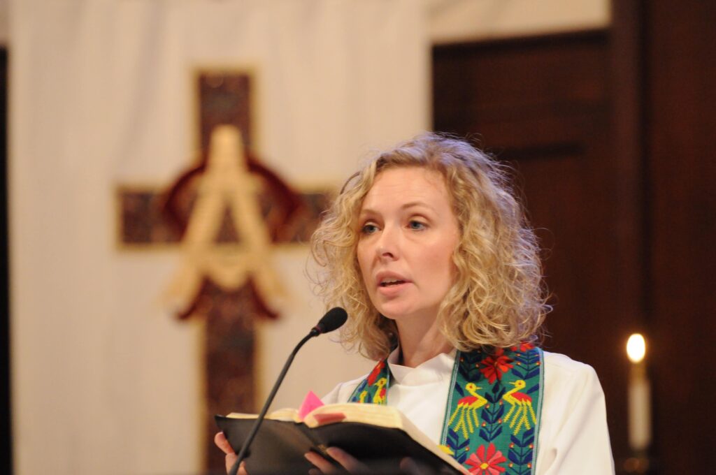 A minister stands in a pulpit during a service.