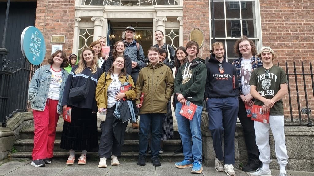 Sixteen people stand in front of the James Joyce Centre in Dublin.